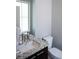 Stylish bathroom features granite countertops, modern fixtures, and a convenient toilet at 2592 S Norse Ct, Lakewood, CO 80228