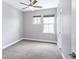 Bright bedroom with carpet, light walls, and a large window at 2592 S Norse Ct, Lakewood, CO 80228