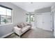 Bright bedroom with neutral carpet, walls, and a large window at 2592 S Norse Ct, Lakewood, CO 80228