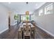 Open-concept living space with hardwood floors, a dining table, and modern lighting at 2592 S Norse Ct, Lakewood, CO 80228