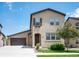 Stucco home with a two-car garage, a charming entry and manicured landscaping at 2592 S Norse Ct, Lakewood, CO 80228