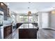 Bright, open kitchen with a large island, stainless steel appliances, and dark wood cabinetry at 2592 S Norse Ct, Lakewood, CO 80228