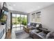 Comfortable living room with a large sectional sofa, hardwood floors, and sliding glass doors to the patio at 2592 S Norse Ct, Lakewood, CO 80228