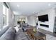 Open-concept living room features hardwood floors, a modern fireplace, and seamless flow to the kitchen and dining area at 2592 S Norse Ct, Lakewood, CO 80228