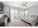 Bright main bedroom with a private balcony, ceiling fan, and ample natural light at 2592 S Norse Ct, Lakewood, CO 80228