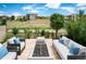 Inviting outdoor patio with comfortable seating and a fire pit, perfect for entertaining and relaxation at 2592 S Norse Ct, Lakewood, CO 80228