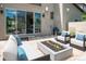 Outdoor living space with modern seating, a fire pit, and seamless access to the indoor living area at 2592 S Norse Ct, Lakewood, CO 80228