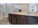 A bathroom featuring a double sink vanity, and glass shower at 24501 E 41St Ave, Aurora, CO 80019
