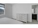 Bright bedroom features a classic dresser, neutral walls, and a view from a window at 24501 E 41St Ave, Aurora, CO 80019