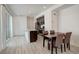 Open dining area with seating for four, adjacent to the kitchen with stainless steel appliances at 24501 E 41St Ave, Aurora, CO 80019