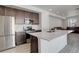 Eat-in kitchen features stainless steel appliances, a breakfast bar, and flows into the living space at 24501 E 41St Ave, Aurora, CO 80019