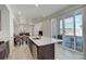 Kitchen island with sink and views of the dining and sliding glass doors at 24501 E 41St Ave, Aurora, CO 80019