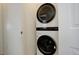Laundry area features a modern stacked washer and dryer unit at 24501 E 41St Ave, Aurora, CO 80019