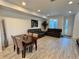 Bright and airy living room and dining room features plank floors and modern furnishings at 24501 E 41St Ave, Aurora, CO 80019
