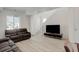 A light and open living room with gray wood-look floors and modern furnishings at 24501 E 41St Ave, Aurora, CO 80019