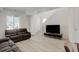 Inviting living room with neutral tones, plush seating, and bright natural light from a large window at 24501 E 41St Ave, Aurora, CO 80019