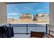 Tranquil porch view, featuring a black metal railing and outdoor seating, perfect for enjoying the neighborhood's scenery at 24501 E 41St Ave, Aurora, CO 80019