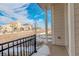 Cozy porch view with black metal railing, showcasing the neighborhood's architectural style under a bright sky at 24501 E 41St Ave, Aurora, CO 80019