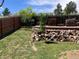 Wide backyard with tiered garden, wooden privacy fence and young trees at 4783 S Taft St, Morrison, CO 80465