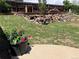 Lush backyard featuring a patio, tiered garden and privacy fence at 4783 S Taft St, Morrison, CO 80465