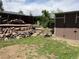 Landscaped backyard featuring stone accents, wooden steps, wooden fence, and convenient storage shed at 4783 S Taft St, Morrison, CO 80465