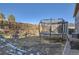 A fenced yard is fitted with a trampoline and shed sitting on a pebble lined garden bed at 4783 S Taft St, Morrison, CO 80465