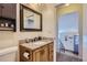 Bathroom features a granite countertop sink and a storage cabinet above the toilet at 4783 S Taft St, Morrison, CO 80465