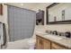 Bathroom with granite countertop vanity, updated fixtures, and shower with patterned curtain at 4783 S Taft St, Morrison, CO 80465