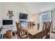 Formal dining room with wood floors, a fireplace with a television, and ample natural light at 4783 S Taft St, Morrison, CO 80465