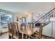 Formal dining room with wood floors, a staircase and a view into the kitchen at 4783 S Taft St, Morrison, CO 80465