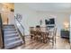 Formal dining room with wood floors, a staircase and a fireplace with a television at 4783 S Taft St, Morrison, CO 80465