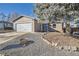 Charming single-story home featuring a well-maintained front yard with a large tree and a two-car garage at 4783 S Taft St, Morrison, CO 80465