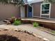 Inviting front porch with dual door entry and landscaped garden pathway at 4783 S Taft St, Morrison, CO 80465
