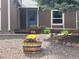 Inviting front yard featuring a wooden barrel planter with vibrant flowers and decorative gravel at 4783 S Taft St, Morrison, CO 80465
