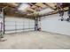 Spacious two car garage with an open ceiling and hanging bike rack with ample storage capabilities at 4783 S Taft St, Morrison, CO 80465