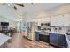 Open concept kitchen with stainless steel appliances, white countertops, and a view of the formal dining room at 4783 S Taft St, Morrison, CO 80465