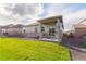 Cozy covered patio and lush lawn create a welcoming outdoor space for relaxation and leisure at 19468 E 65Th Pl, Aurora, CO 80019