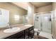 Bathroom featuring a double sink vanity and glass enclosed shower at 19468 E 65Th Pl, Aurora, CO 80019