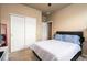 A cozy secondary bedroom featuring a bed, sliding closet doors, and neutral carpet at 19468 E 65Th Pl, Aurora, CO 80019