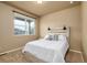 Bright and airy bedroom with a large window offering natural light and a calming view at 19468 E 65Th Pl, Aurora, CO 80019