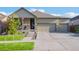Well-maintained home showcases a manicured lawn, a welcoming front porch, and a spacious three-car garage at 19468 E 65Th Pl, Aurora, CO 80019