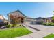 Charming single-story home boasts a three-car garage, landscaped yard, and inviting porch, offering both comfort and curb appeal at 19468 E 65Th Pl, Aurora, CO 80019