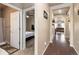 Hallway view showcasing hardwood floors and entrances to a bedroom with bath and living areas at 19468 E 65Th Pl, Aurora, CO 80019