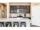 Well-appointed kitchen featuring sleek cabinets, modern appliances, and a functional island with barstool seating at 19468 E 65Th Pl, Aurora, CO 80019