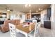 Open-concept living area with a dining table, kitchen, and comfortable seating, ideal for entertaining at 19468 E 65Th Pl, Aurora, CO 80019