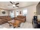 Inviting living room featuring neutral tones, ceiling fan, and comfortable seating for relaxing and entertaining at 19468 E 65Th Pl, Aurora, CO 80019