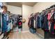 Well-organized walk-in closet with ample storage, shelving, and hanging space for clothes and accessories at 19468 E 65Th Pl, Aurora, CO 80019