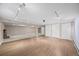 Spacious basement with hardwood flooring and carpeted areas, complemented by track lighting at 37 E 14Th Pl, Broomfield, CO 80020