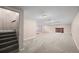 Large basement with carpeting, a brick fireplace, and access to stairs at 37 E 14Th Pl, Broomfield, CO 80020