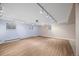 Finished basement featuring laminate flooring, track lighting, and multiple windows at 37 E 14Th Pl, Broomfield, CO 80020